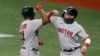 FILE - Boston Red Sox third baseman Rafael Devers gets an elbow bump from the batboy (right) after hitting a two-run home run at Tropicana Field, Sept. 10, 2020, St. Petersburg, Florida. (Reinhold Matay-USA TODAY Sports)