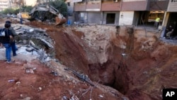 FILE - A crater is left in the ground near the site of the assassination of Hezbollah leader Hassan Nasrallah in Beirut's southern suburbs on Sept. 29, 2024. Analysts say Nasrallah's death, as well as those of other Hezbollah leaders, has weakened the militant group.