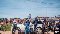 Musician-turned-politician Bobi Wine (on top of car) greets supporters as he makes his way to be officially nominated as a presidential candidate, in Kampala, Uganda, Nov. 03, 2020.