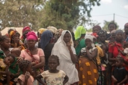 FILE - Displaced women gather at the Centro Agr‡rio de Napala, where hundreds of displaced who arrived in recent months are sheltered, fleeing attacks by armed insurgents in different areas of the province of Cabo Delgado, Mozambique, Dec. 11, 2020.