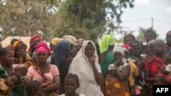 FILE - Displaced women gather at the Centro Agr‡rio de Napala, where hundreds of displaced who arrived in recent months are sheltered, fleeing attacks by armed insurgents in different areas of the province of Cabo Delgado, Mozambique, Dec. 11, 2020.
