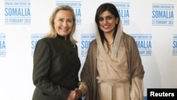 Hillary Clinton shakes hands with Hina Rabbani Khar in London at a conference of world leaders meeting to discuss Somalia. "Time is of the essence," she said. February 23, 2012 (Reuters) 