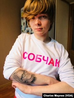 Russian journalist Vitaly Bespalov shows off his 'SOBCHAK' sweatshirt and matching tattoo in St. Petersburg, December 2017. Bespalov was an active supporter of liberal presidential candidate Ksenia Sobchak in the country's March 2018 elections.