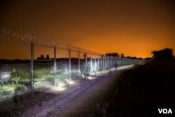 Night shots of the newly erected border fence in Asotthalom, Hungary. (Gabor Ancsin / VOA)