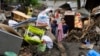 
Residents try to recover belongings from their damaged homes after a landslide triggered by Tropical Storm Trami struck Talisay, Batangas province, Philippines, Oct. 26, 2024.