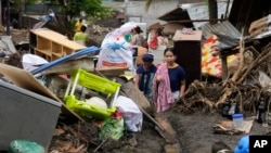 
Residents try to recover belongings from their damaged homes after a landslide triggered by Tropical Storm Trami struck Talisay, Batangas province, Philippines, Oct. 26, 2024.