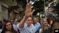 FILE - Marcelo Crivella, bishop of the Universal Church of the Kingdom of God, campaigns for governor of Rio de Janeiro state, for the Brazilian Republican Party, in Copacabana, Rio de Janeiro, Brazil, Sept. 29, 2014.