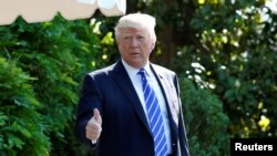 U.S. President Donald Trump gestures as he walks on the South Lawn of the White House in Washington, DC, U.S., before his departure to Groton, Connecticut, May 17, 2017. 