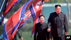 North Korean leader Kim Jong Un, right, and Choe Ryong Hae, vice-chairman of the central committee of the Workers' Party, arrive for the official opening of the Ryomyong residential area, in Pyongyang, North Korea, April 13, 2107. 