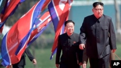 FILE - North Korean leader Kim Jong Un, right, and Choe Ryong Hae, vice-chairman of the central committee of the Workers' Party, arrive for the official opening of the Ryomyong residential area, in Pyongyang, North Korea, April 13, 2107. Choe is one of the North Korean officials sanctioned by the U.S. Sunday.