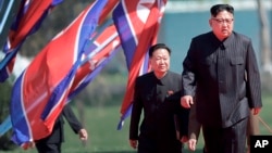 North Korean leader Kim Jong Un, right, and Choe Ryong Hae, vice-chairman of the central committee of the Workers' Party, arrive for the official opening of the Ryomyong residential area, in Pyongyang, North Korea, April 13, 2107. 