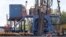 A crew works on a gas-drilling rig at a well site for shale-based natural gas in Zelienople, Pa., June 25, 2012.