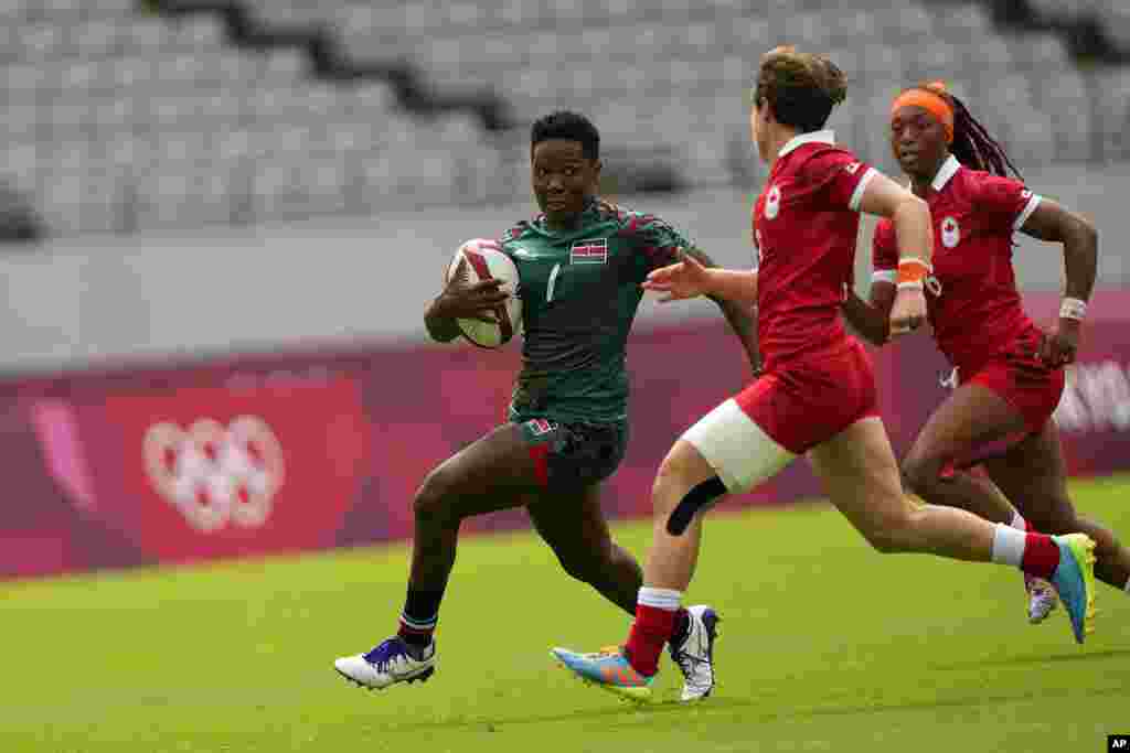 Kenya&#39;s Leah Wambui, left, is pursued by Canada&#39;s Ghislaine Landry, second right, and Charity Williams, in their women&#39;s rugby sevens 9-10 placing match at the 2020 Summer Olympics, Saturday, July 31, 2021 in Tokyo, Japan. (AP Photo/Shuji Kajiyama)