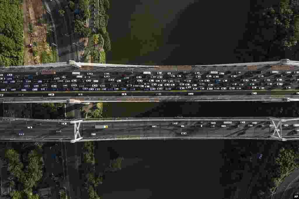 People cross the Juan Pablo Duarte Bridge in Santo Domingo, Dominican Republic.