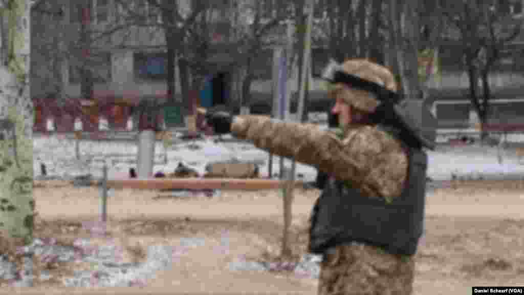 A soldier is seen near unexploded rocket in a residential area of Kramatorsk, eastern Ukraine, Feb. 10. 2015.