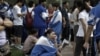 Chinese students wait to take an annual college entrance examinations. Many more would if not for the Hukou system.