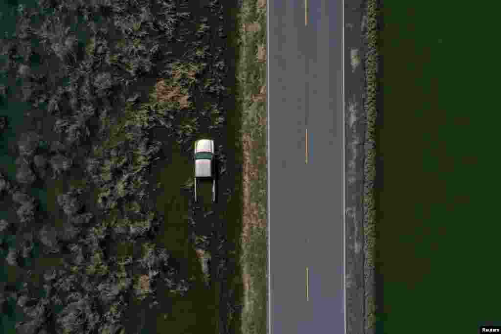 A vehicle is submerged in flood waters in the aftermath of Hurricane Delta in Creole, Louisiana, Oct. 10, 2020.