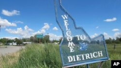 FILE - A sign welcomes residents and visitors to the tiny town in Dietrich, Idaho, May 26, 2016. Residents of the Idaho town have been told not to drink the water after a fired municipal worker was found dead in his home by emergency workers who were later hospitalized.