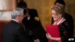 French actress Catherine Deneuve (R), a winner of the 30th Praemium Imperiale award receives her certification during the award ceremony in Tokyo, Oct. 23, 2018. 