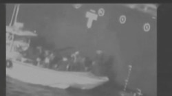 Still image taken from a U.S. military handout video purports to show Iran's Revolutionary Guard (IRGC) removing an unexploded limpet mine from the side of the Kokuka Courageous Tanker.
