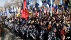 Ultra-right activists holds march during a rally against tycoons in national politics and economy in central Kiev, Ukraine, April 3, 2018.