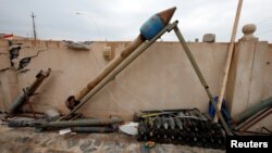 FILE - Weapons and ammunition belonging to Islamic State militants are seen in the town of Bashiqa, east of Mosul, Iraq.