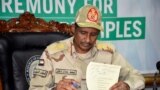 FILE - General Hamdan Dagalo, head of the paramilitary Rapid Support Forces, signs the initial agreement on a roadmap for peace talks on behalf of the Sudanese government in Juba, South Sudan, Sept. 11, 2019.