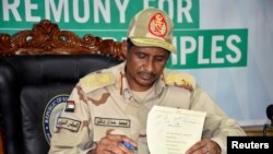 FILE - General Hamdan Dagalo, head of the paramilitary Rapid Support Forces, signs the initial agreement on a roadmap for peace talks on behalf of the Sudanese government in Juba, South Sudan, Sept. 11, 2019.