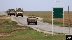 FILE - U.S. troops patrol near the Turkish border in Hasakah province, Syria, Nov. 4, 2018. 