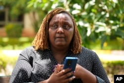 FILE—Njeri Migwi, a woman human rights defender and the Co-Founder of Usikimye ('Don't be Silent'), an organization working against gender-based violence, in downtown Nairobi, March 6, 2024.