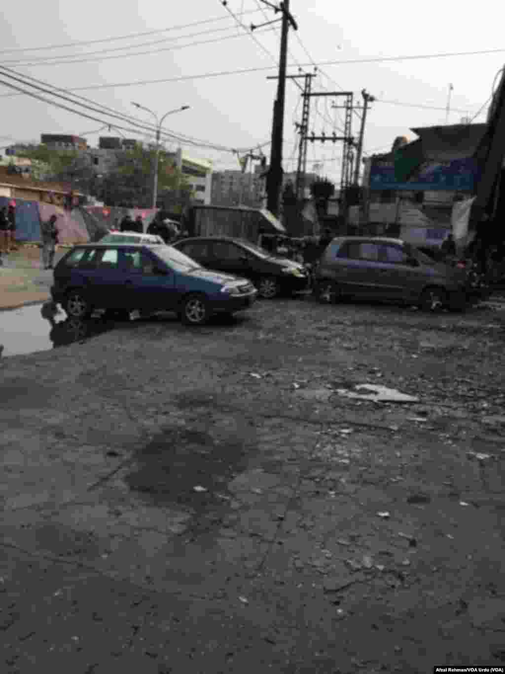 Cars are damaged after an apparent suicide bombing in Lahore, Pakistan, Feb. 17, 2015.