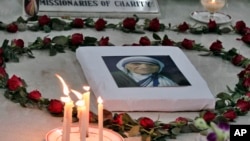 FILE - A portrait of Mother Teresa is seen on her tomb in Kolkata (formerly Calcutta), India, Sept. 5, 2015. The Nobel Peace Prize winning Catholic nun who spent 45 years serving for the poor, sick, orphaned, and dying, died in Kolkata Sept 5, 1997, at age 87.