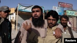 Relatives of police cadets wait for word outside the Police Training Center after an attack on the center in Quetta, Pakistan Oct. 25, 2016.