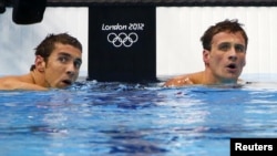 Michael Phelps (L) and Ryan Lochte of the U.S. check their times after their men's 200m individual medley semi-final during the London 2012 Olympic Games at the Aquatics Centre, August 1, 2012. 