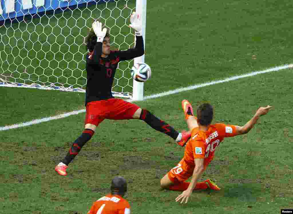 Mexico's goalkeeper Guillermo Ochoa makes a save on a shot by Klaas-Jan Huntelaar of the Netherlands at the Castelao arena in Fortaleza, June 29, 2014.
