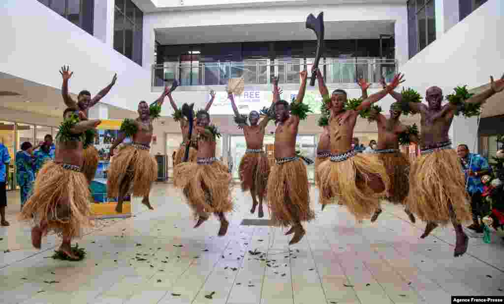 Traditional dancers in grass skirts welcome holidaymakers in Nadi as Fiji opens its borders to international travelers for the first time since the Covid-19 pandemic swept the globe and devastated its tourism-reliant economy.