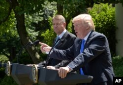 President Donald Trump, right, speaks during a news conference with Romania's President Klaus Werner Iohannis, left, in the Rose Garden of the White House, June 9, 2017.