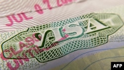 FILE - A photo illustration shows a U.S. visa stamp on a foreign passport in Los Angeles, California, June 6, 2020.