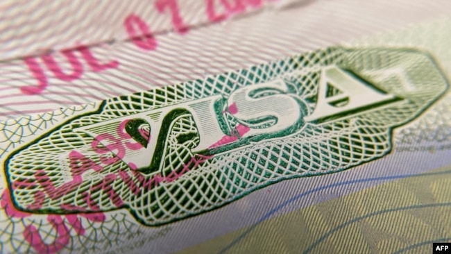 FILE - A photo illustration shows a U.S. visa stamp on a foreign passport in Los Angeles, California, June 6, 2020.