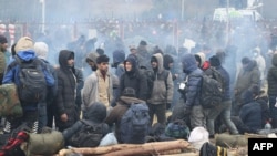 Migrants aiming to enter Poland gather near the Bruzgi-Kuznica crossing on the Belarusian-Polish border in the Grodno region on November 16, 2021. (Maxim Guchek / BELTA / AFP)