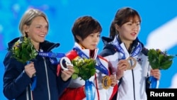 Gold medalist China's Li Jianrou (C), silver medalist Italy's Arianna Fontana (L) and bronze medalist South Korea's Park Seung-hi celebrate during the medal ceremony for the women's 500 meters short track speed skating event at the 2014 Sochi Winter Olymp