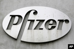 FILE - The Pfizer logo is displayed on the exterior of a former Pfizer factory, on May 4, 2014, in the Brooklyn borough of New York. Pfizer is one of the companies working on a new weight-loss pill. (AP Photo/Mark Lennihan, File)
