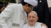 FILE - The Grand Imam of Istiqlal Mosque Nasaruddin Umar, left, hugs Pope Francis during a family photo following an interreligious meeting with religious leaders at the Istiqlal Mosque in Jakarta, Sept. 5, 2024. 