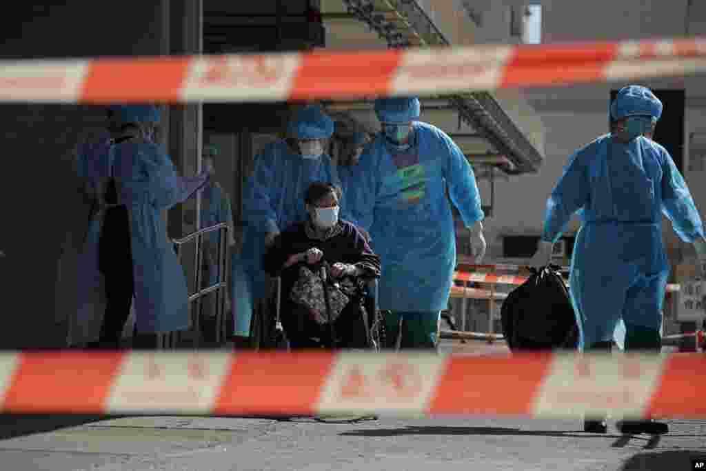 A resident of The Salvation Army Lung Hang Residence for Senior Citizens is evacuated by medical staff from the Centre for Health Protection, after employees of the nursing home were found to have the coronavirus, in Hong Kong. 