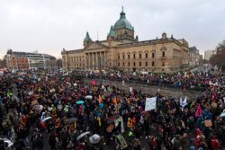 Thousands of demonstrators attend a protest climate strike rally of the 'Friday For Future Movement' in front of the Federal Administrative Court building in Leipzig, Germany, Nov. 29, 2019.