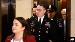 Army Lieutenant Colonel Alexander Vindman, a military officer at the National Security Council, center, arrives on Capitol Hill in Washington, Oct. 29, 2019, to be interviewed as part of the impeachment inquiry into President Donald Trump.