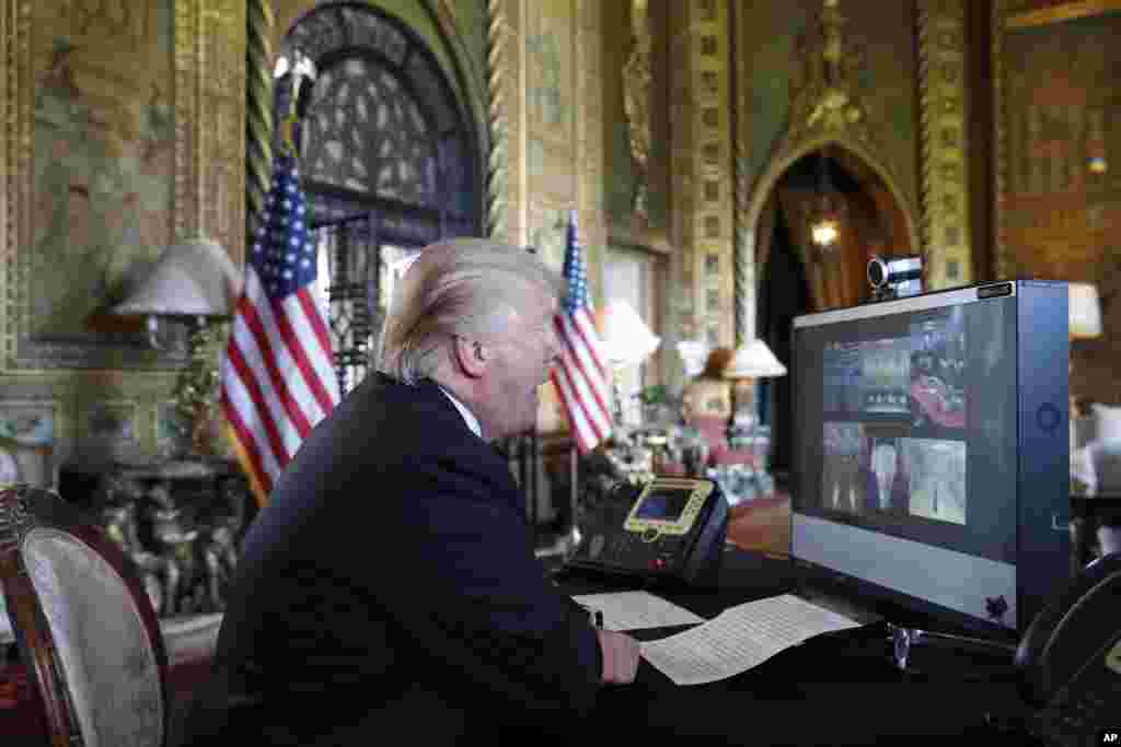 President Donald Trump speaks with members of the armed forces via video conference at his private club, Mar-a-Lago, on Thanksgiving, Nov. 23, 2017, in Palm Beach, Florida.