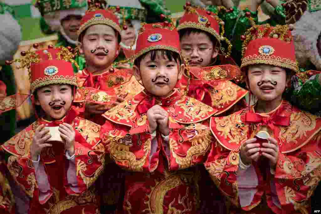 Children wearing traditional costumes are seen during preparations for Chinese lunar new year celebrations in Hong Kong. The Chinese &quot;year of the sheep&quot; begins on Feb. 19.