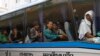 FILE PHOTO - Cambodian migrant workers sit in a bus upon arrival at Cambodia-Thailand's international border gate in Poipet, Cambodia, from Thailand, Tuesday, June 17, 2014.