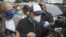 Former Panama president Ricardo Martinelli is surrounded by reporters as he arrives at the prosecutor's office in Panama City, on July 2, 2020, amid the novel coronavirus pandemic. 